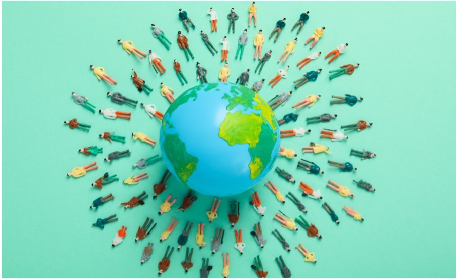 Miniature figures radiating outward from a globe, representing global reach